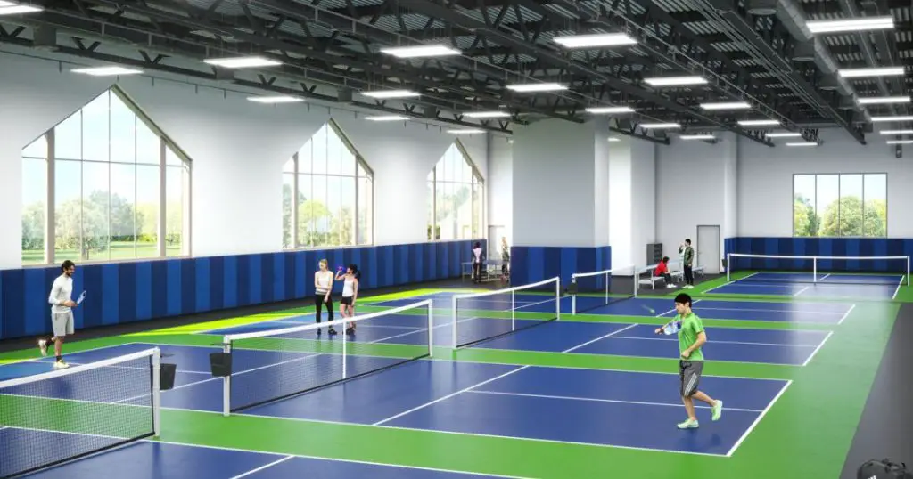 Sky fitness pickleball complex with people playing piclkeball On 4 courts. 