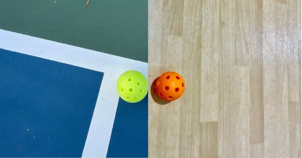yellow outdoor pickleball on court surface next to orange indoor ball on hardwood floor